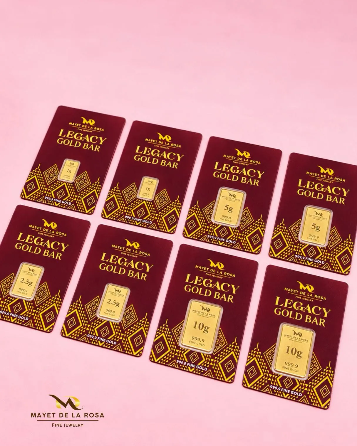 Eight Legacy Gold Bar cards laid out on a pink surface, in 1 g, 2.5 g, 5 g and 10 g sizes